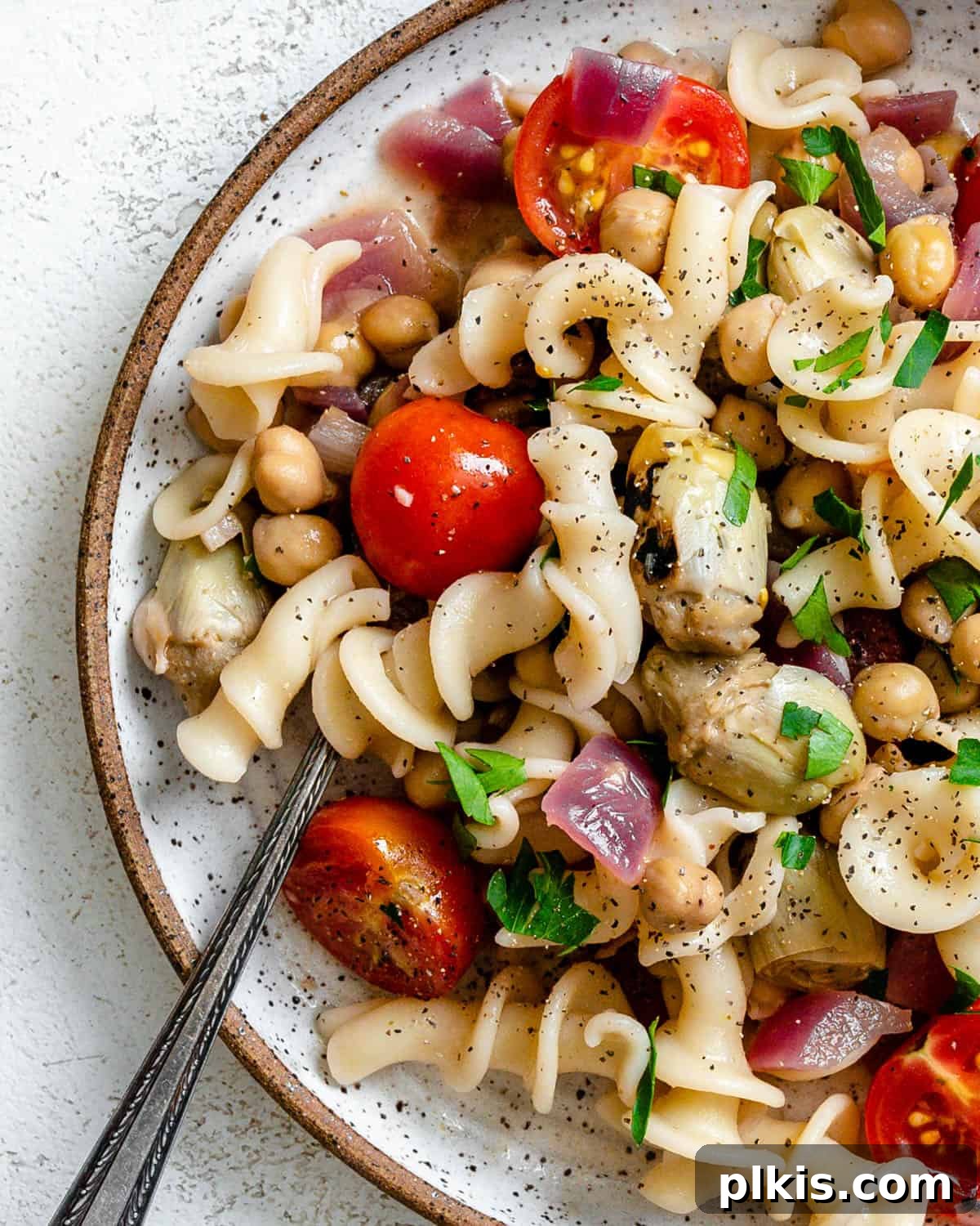 Refreshing Summer Pasta Salad 8 Completed Summer Pasta Salad in a bowl with a serving fork, ready to be enjoyed.