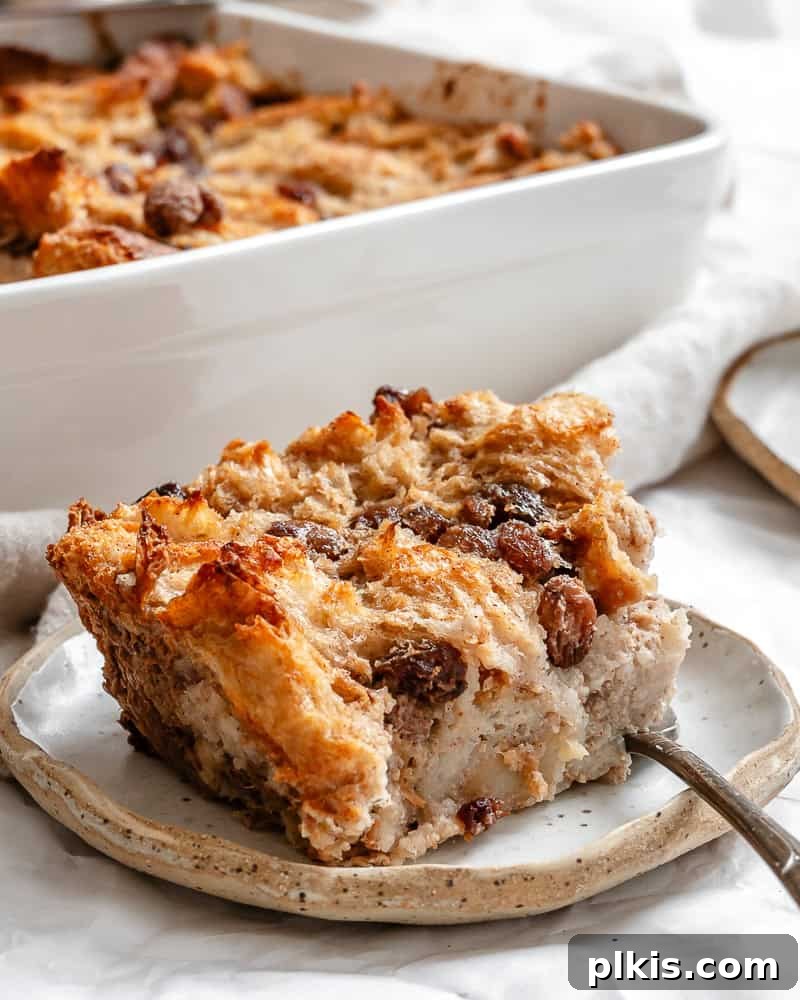 Decadent Vegan Bread Pudding 8 Close-up of baked Vegan Bread Pudding in a baking dish, showing its golden-brown top and soft texture.
