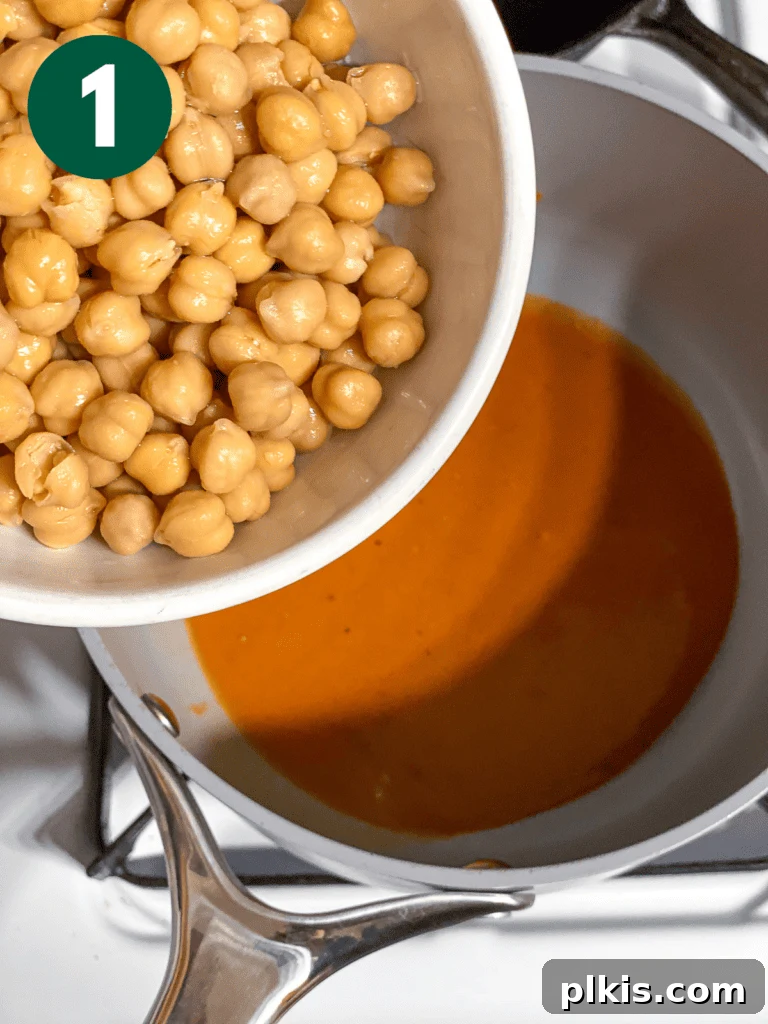Tangy BBQ Chickpea Wraps 5 Process shot of adding chickpeas to a pot of BBQ sauce.