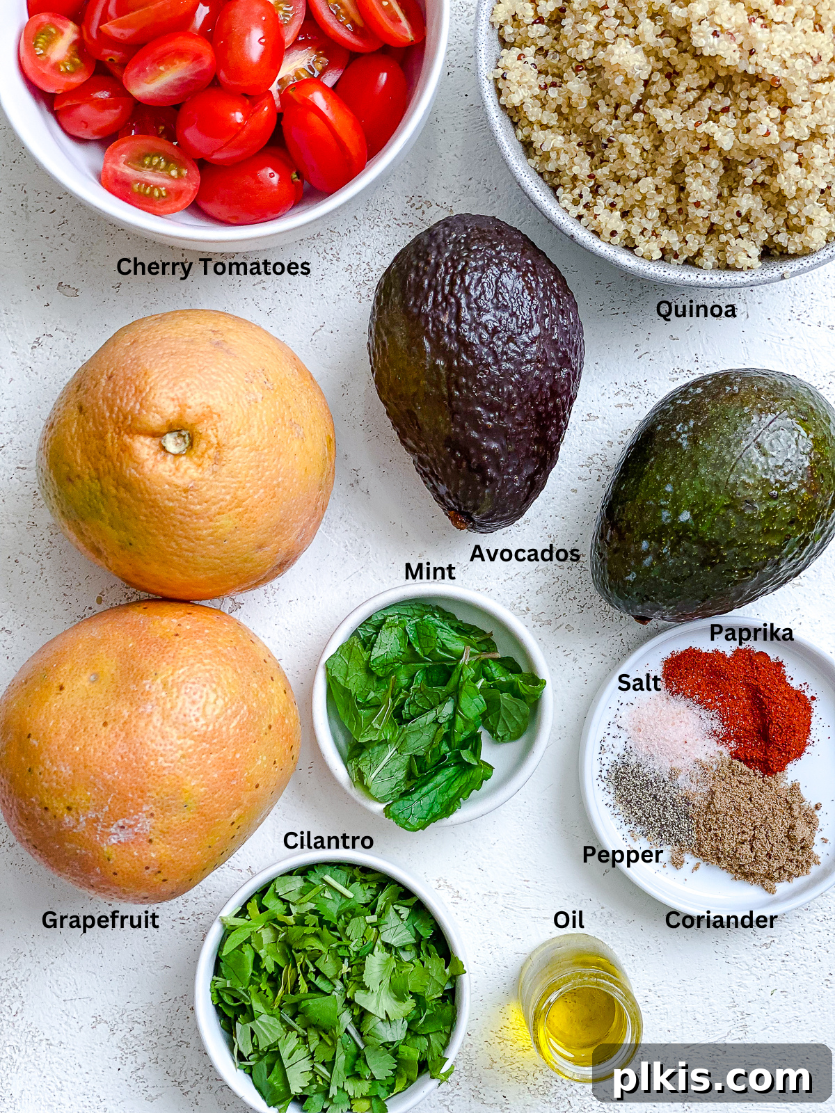 Ingredients for Avocado Quinoa Salad with Grapefruit measured out on a white surface, ready for preparation.