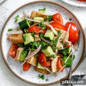 completed Panzanella Salad plated against a white surface