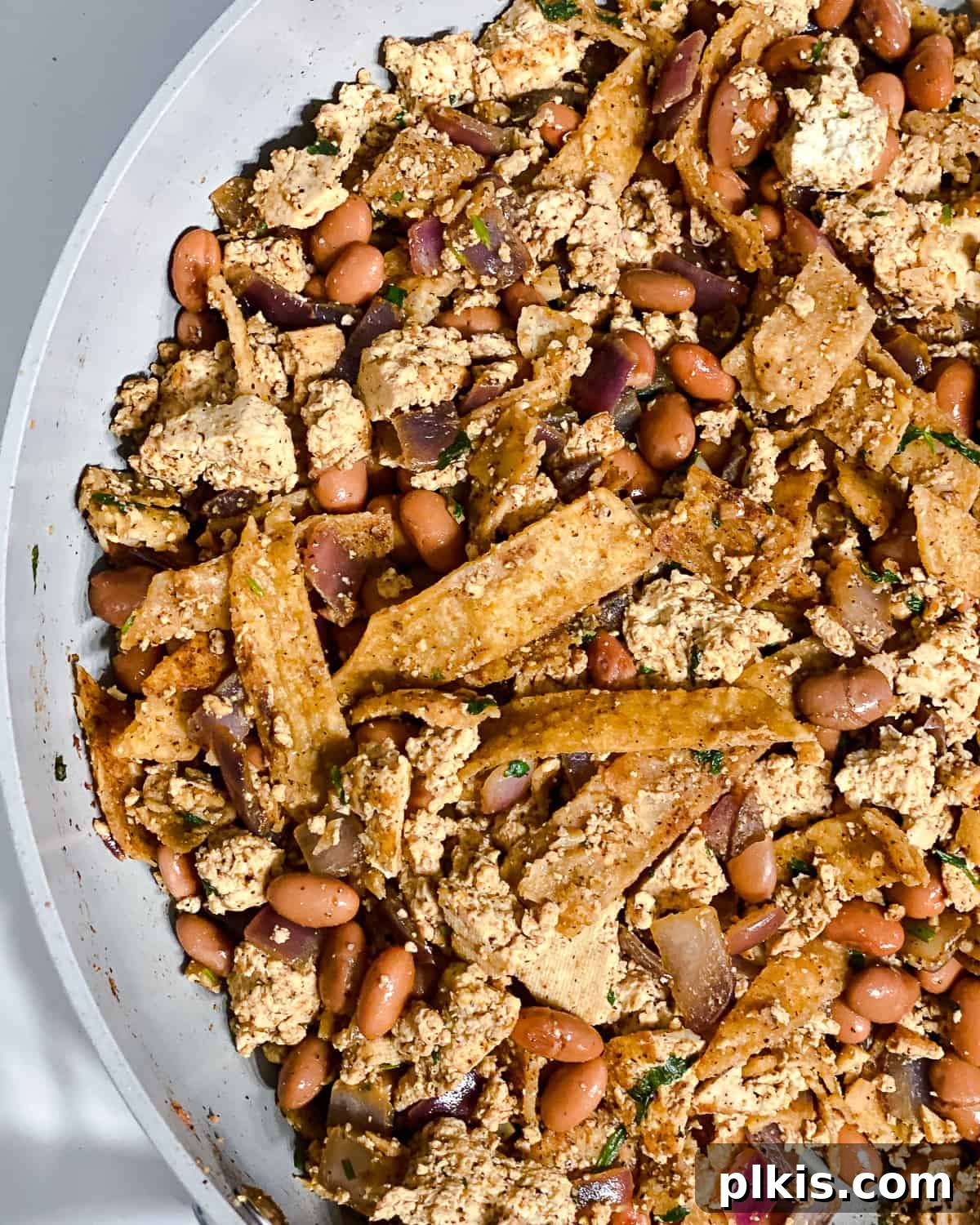 Vegan Chilaquiles Red or Green 12 Process shot showing all ingredients being mixed together in the pan, creating a cohesive and flavorful Vegan Chilaquiles dish.