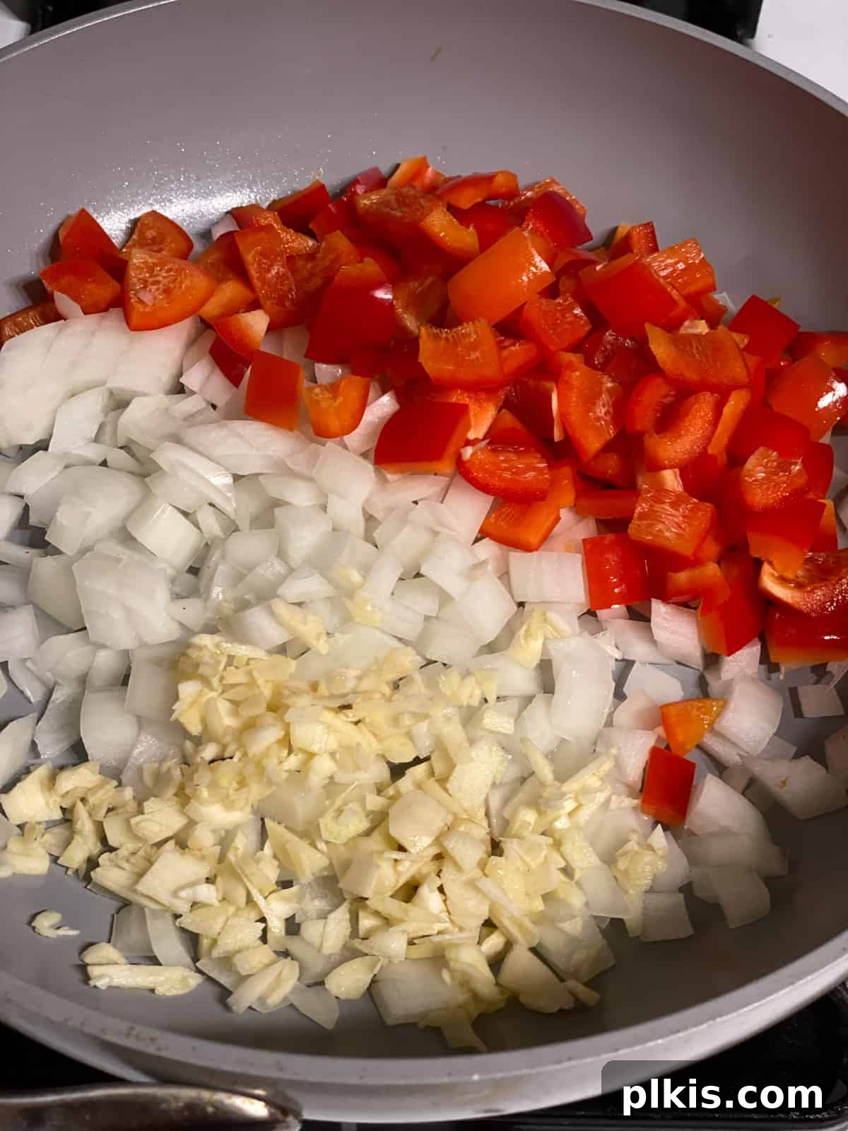 Plant-Powered Lentil Tacos 5 Second step of making lentil tacos: Onions, garlic, and bell pepper are sautéing in a pan.