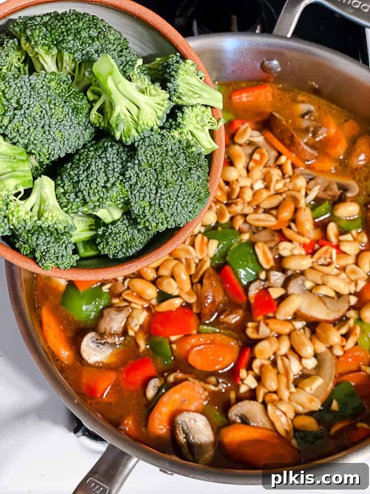 Spicy Kung Pao Vegetable Stir-fry 6 Process shot showing adding broccoli to pan.