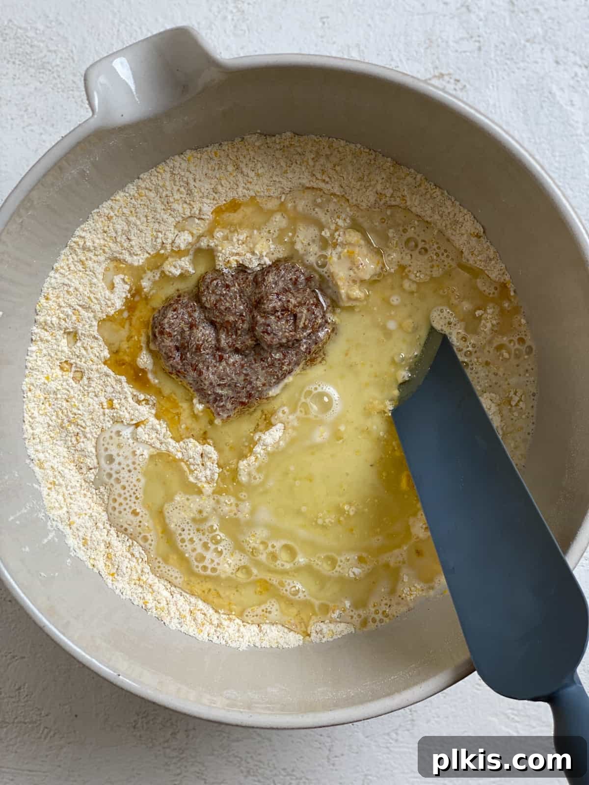 Golden Crust Vegan Cornbread in a Cast Iron Skillet 11 process shot of mixing ingredients together in bowl, showing a slightly lumpy batter