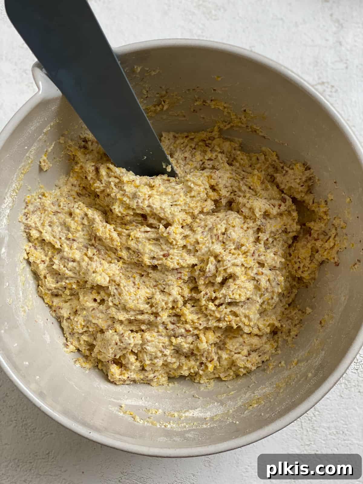 Golden Crust Vegan Cornbread in a Cast Iron Skillet 12 process shot of mixing ingredients together in bowl, showing a fully combined batter