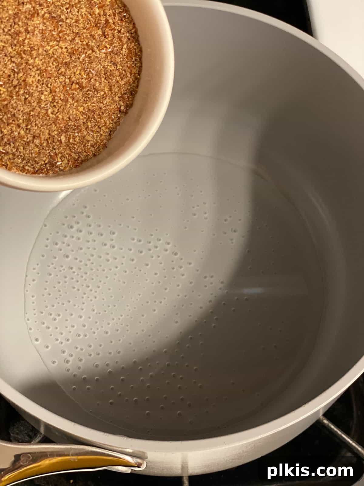 Golden Crust Vegan Cornbread in a Cast Iron Skillet 5 process shot of adding flaxseed to water in pan