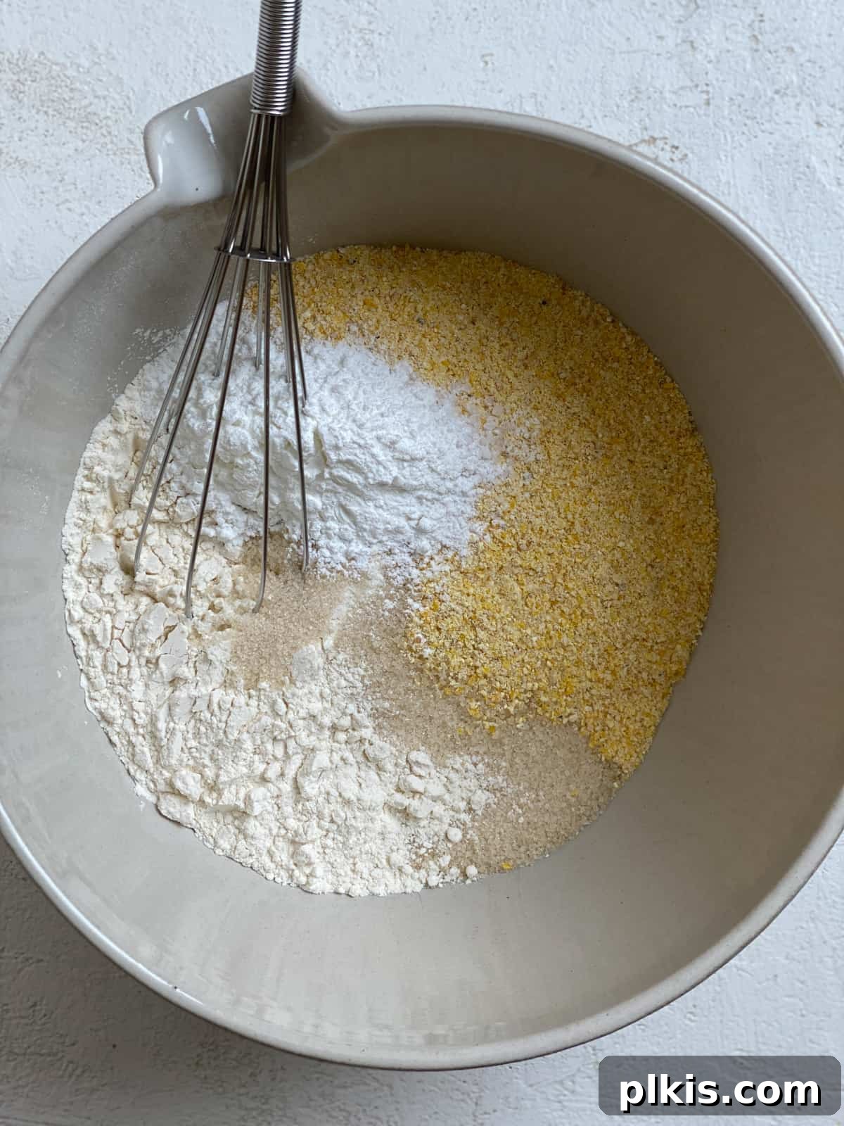Golden Crust Vegan Cornbread in a Cast Iron Skillet 7 process shot of mixing dry ingredients for Vegan Cornbread Recipe Cast Iron Skillet in a bowl