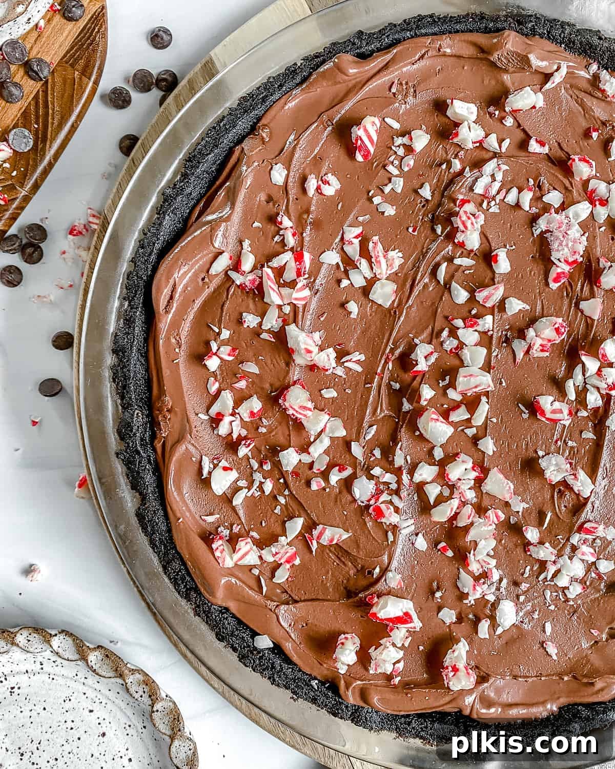 Decadent Vegan Peppermint Chocolate Pie 6 A completed Silken Chocolate Peppermint Pie, elegantly presented against a clean white background, highlighting its smooth texture and festive topping.