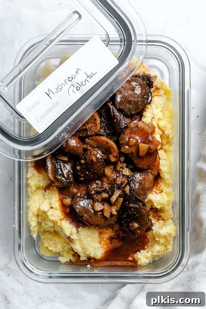Velvety Polenta with Earthy Mushrooms 9 Completed Creamy Polenta with Mushrooms in a clear storage container, ready for refrigeration.