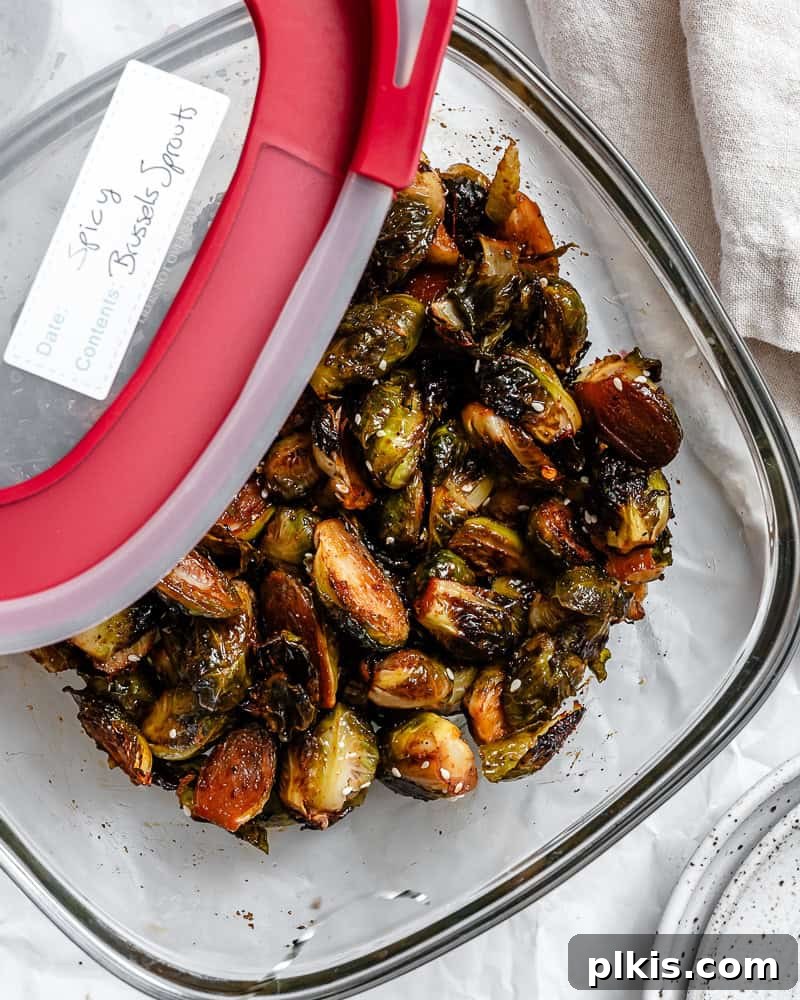 Completed Crispy Brussels Sprouts in a storage container, ready for refrigeration.