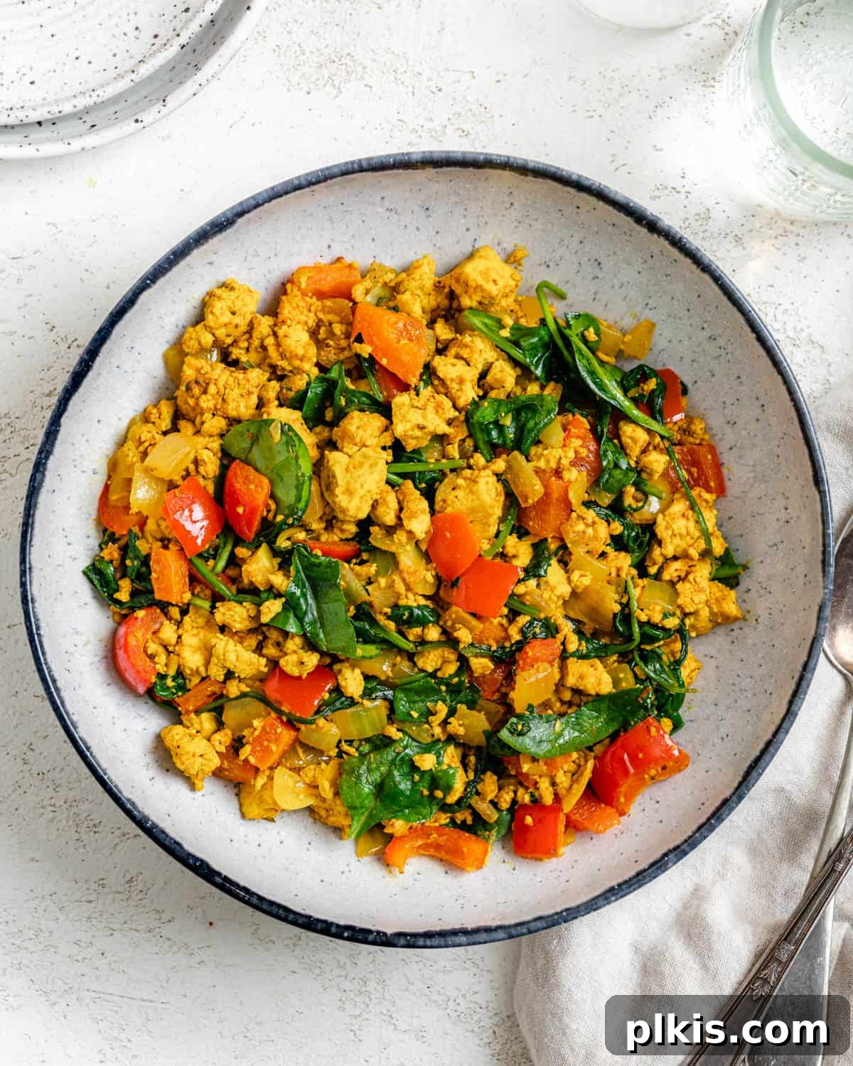 Fluffy and Flavorful Vegan Tofu Scramble with Garden Veggies 11 Another enticing shot of the completed vegan tofu scramble with veggies, served on a plate against a soft, bright background.