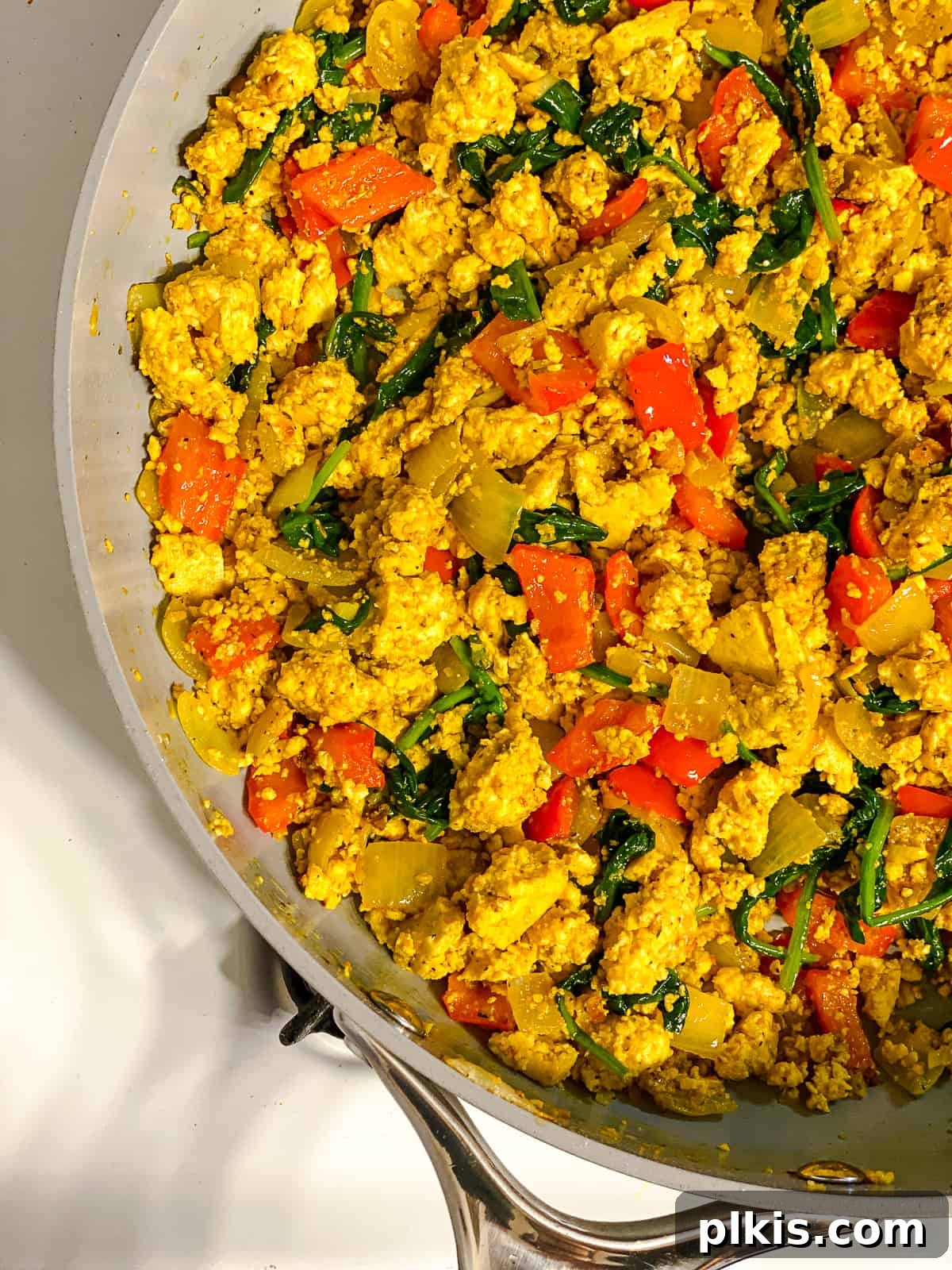 Fluffy and Flavorful Vegan Tofu Scramble with Garden Veggies 9 Process shot of the completed vegan tofu scramble being mixed in the pan, ready to serve.