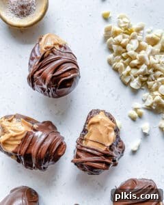 peanut butter stuffed dates being coated in chocolate with nuts in the background