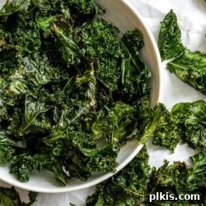 Completed Crispy Baked Kale Chips in a bowl, showcasing their perfect crunch and seasoning.