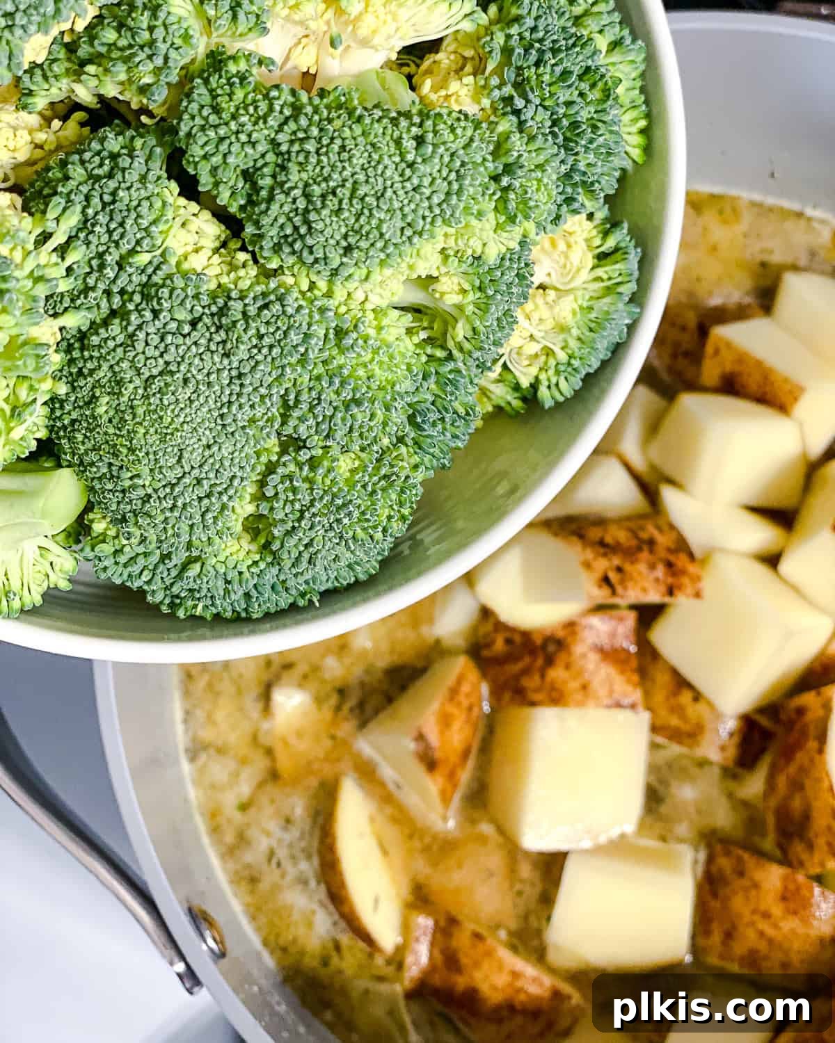 Process shot: Adding fresh broccoli florets to the pot with other soup ingredients.
