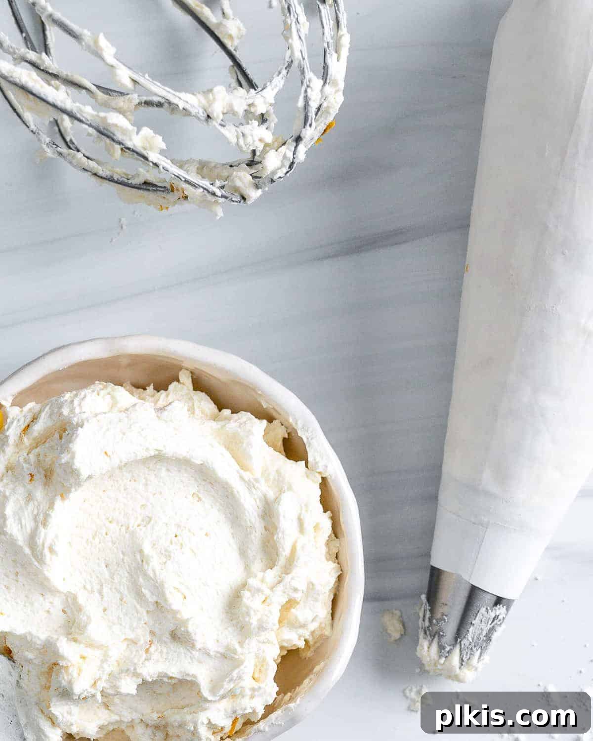 Luscious Vegan Lemon Buttercream 8 A beautifully textured bowl of light yellow vegan lemon buttercream frosting, perfectly smooth and fluffy, placed against a clean white background, inviting you to indulge.