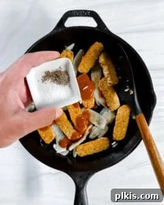 Process of adding spices to pot with tempeh