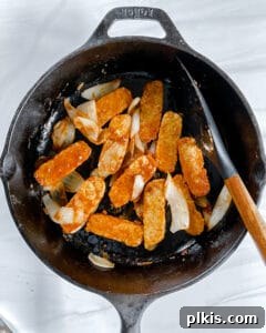 Process showing cooking tempeh in a black pan