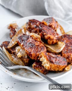 Sweet & Smoky Tempeh BBQ 13 Completed BBQ Tempeh plated on a white plate against a light background