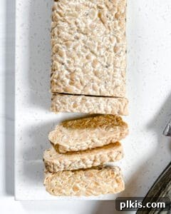 Sweet & Smoky Tempeh BBQ 5 Sliced tempeh on a white surface