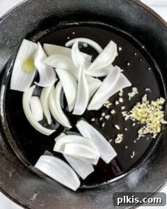 Process showing onions and garlic on pan