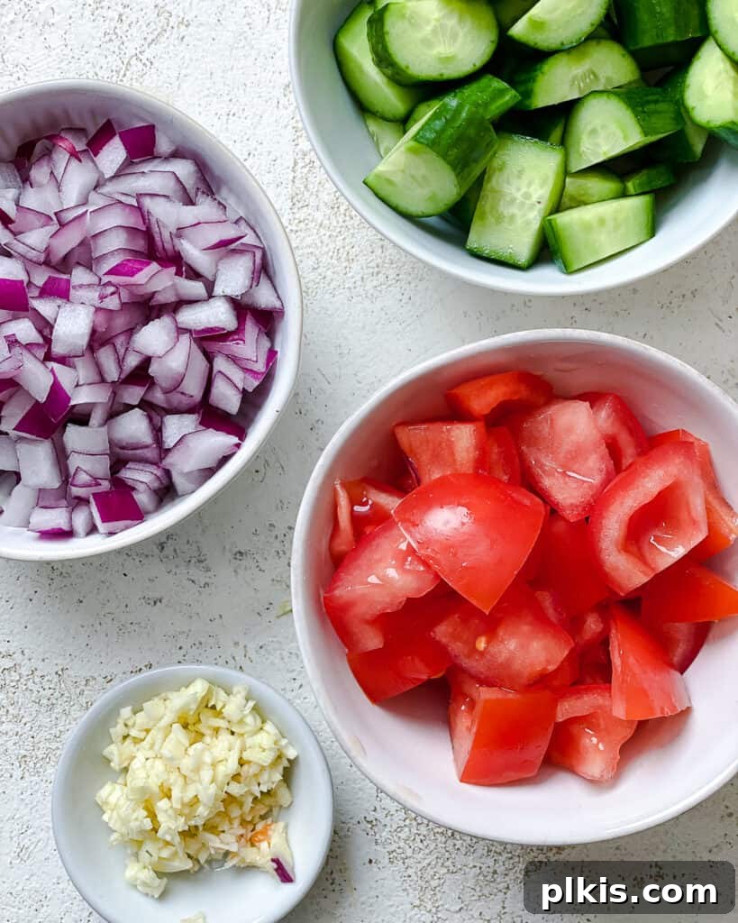 ingredients for Mediterranean Chickpea Salad [With Lentils] measured out against a white surface