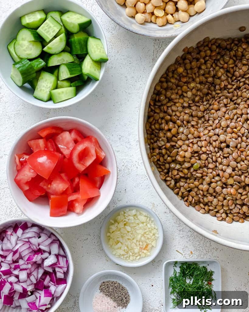 ingredients for Mediterranean Chickpea Salad [With Lentils] measured out against a white surface