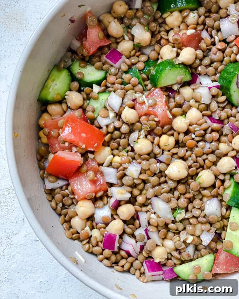 completed Mediterranean Chickpea Salad [With Lentils] plated against a white background