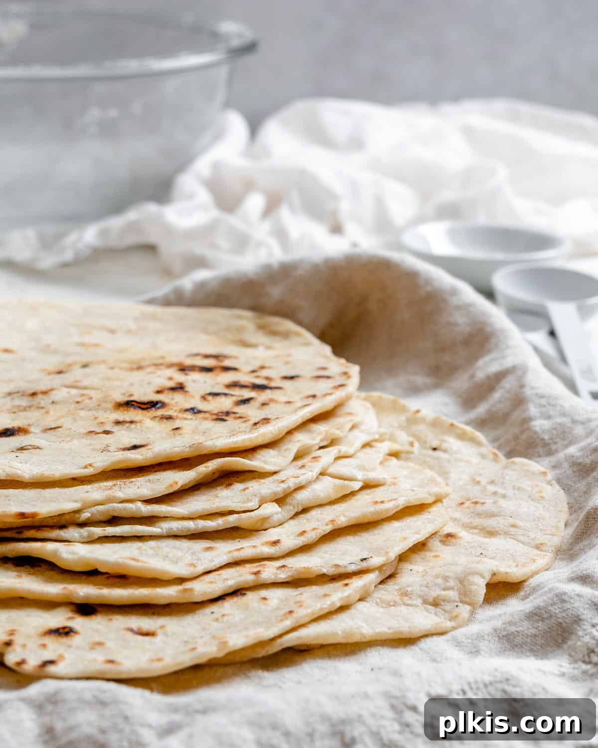 Handcrafted Flour Tortillas 2 Completed Tortillas de Harina – Handmade Flour Tortillas stacked on one another against a white surface, showcasing their soft, inviting texture.