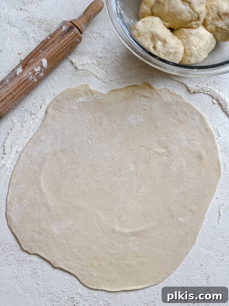 Handcrafted Flour Tortillas 12 Process shot showing a perfectly rolled out dough circle against a white surface, ready for cooking.