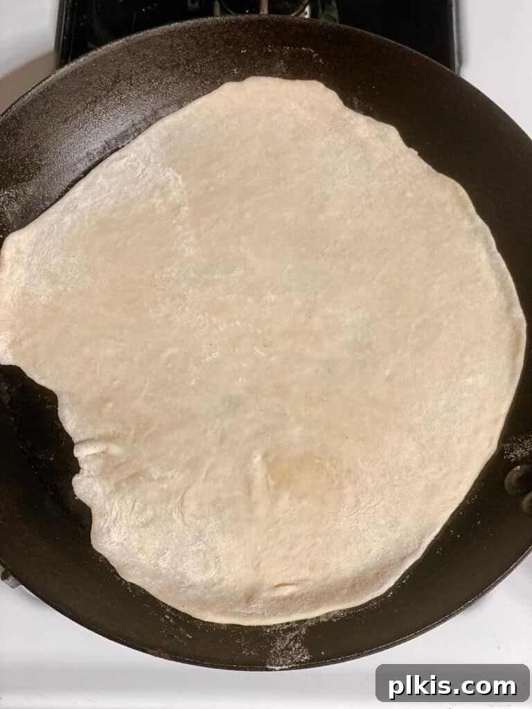 Handcrafted Flour Tortillas 13 Process shot showing a rolled out dough circle placed on a hot pan.