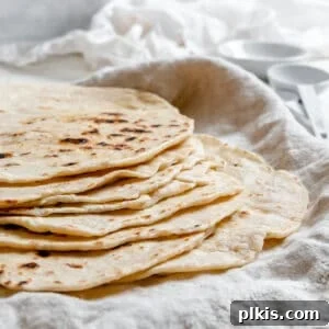 Handcrafted Flour Tortillas 16 completed Tortillas de Harina – Handmade Flour Tortillas stacked on one another against a white surface