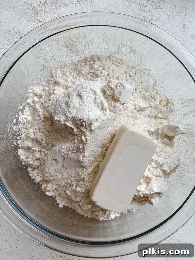 Handcrafted Flour Tortillas 4 Process shot of adding dry ingredients to a mixing bowl, showing flour and bits of vegan butter.