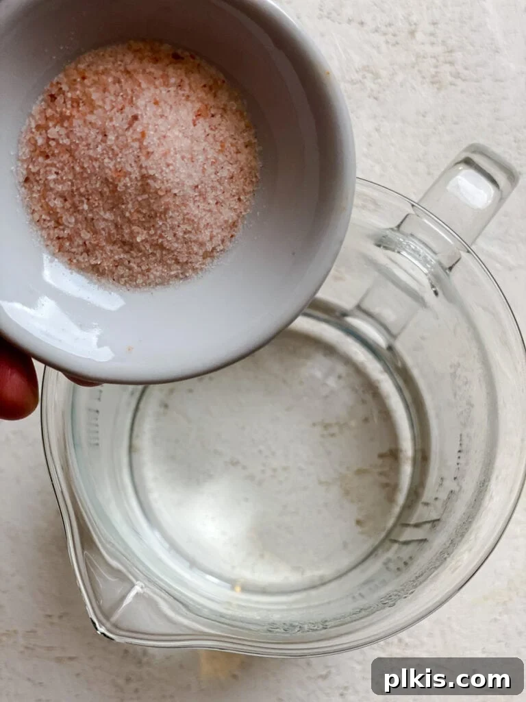 Handcrafted Flour Tortillas 6 Process shot of salt dissolving in hot water in a pitcher.