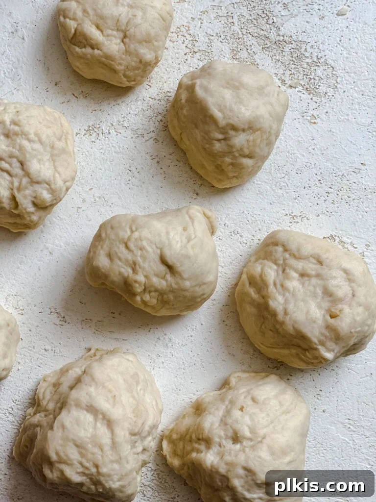 Handcrafted Flour Tortillas 9 Several uniform balls of tortilla dough arranged on a white surface.