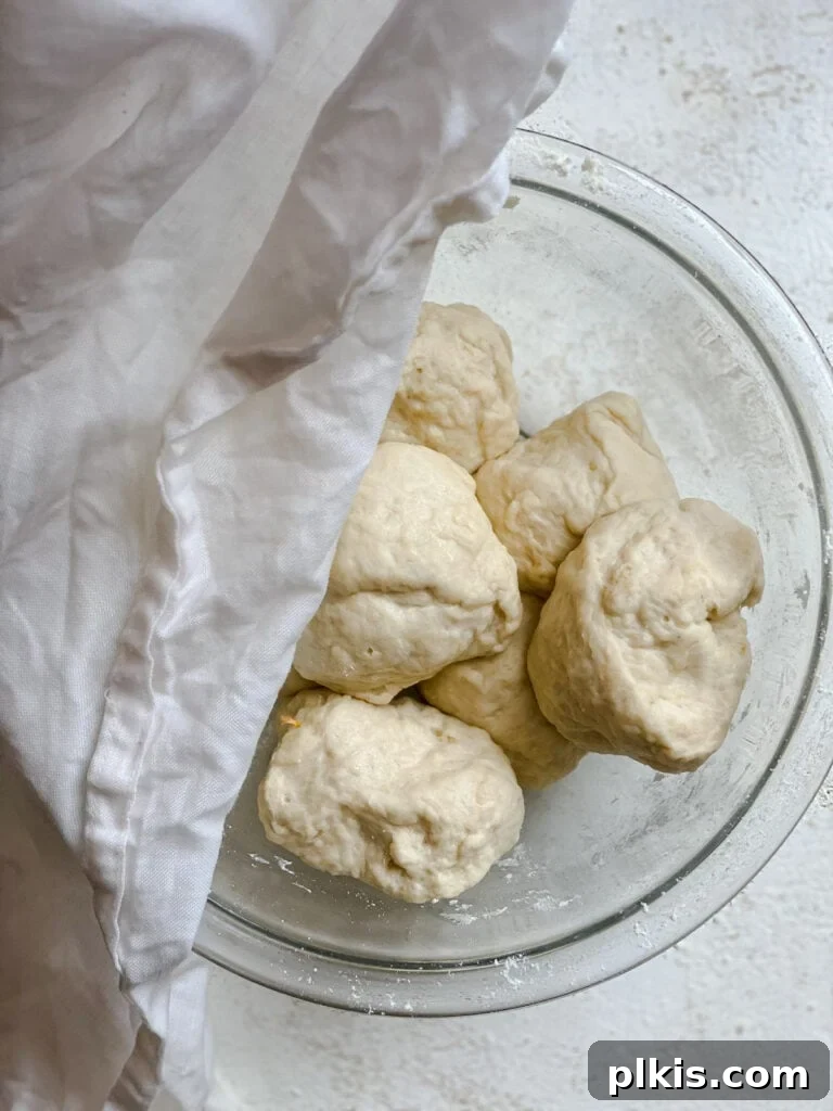Handcrafted Flour Tortillas 10 Process shot of covering the balls of dough in a glass bowl with a damp towel.