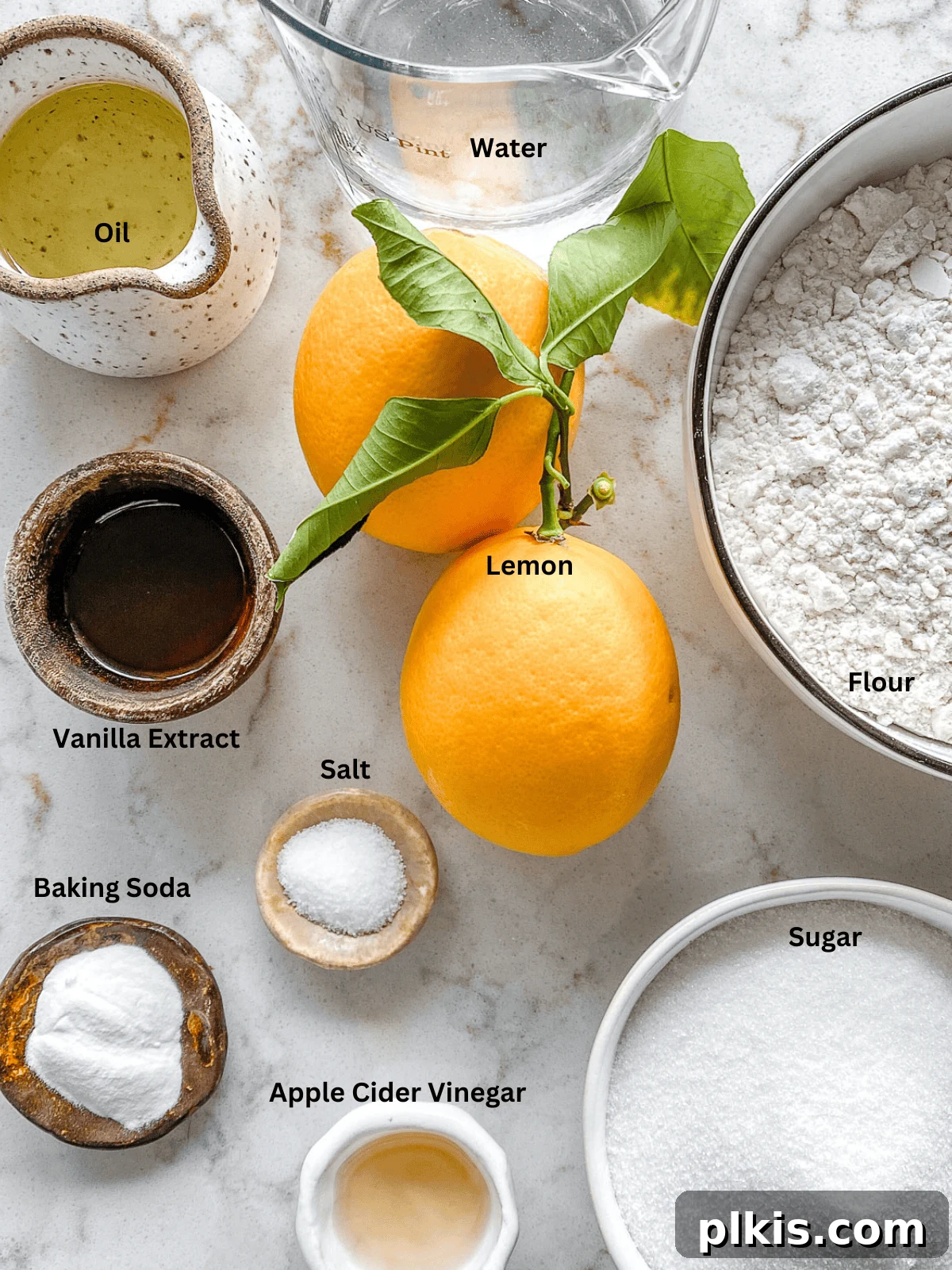 Effortless Vegan Lemon Cupcakes 3 All the measured ingredients for vegan lemon cupcakes laid out on a clean white surface.