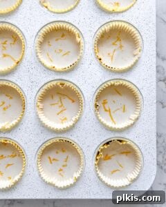 Effortless Vegan Lemon Cupcakes 5 Cupcake batter carefully poured into paper liners inside a muffin tin, ready to be baked.