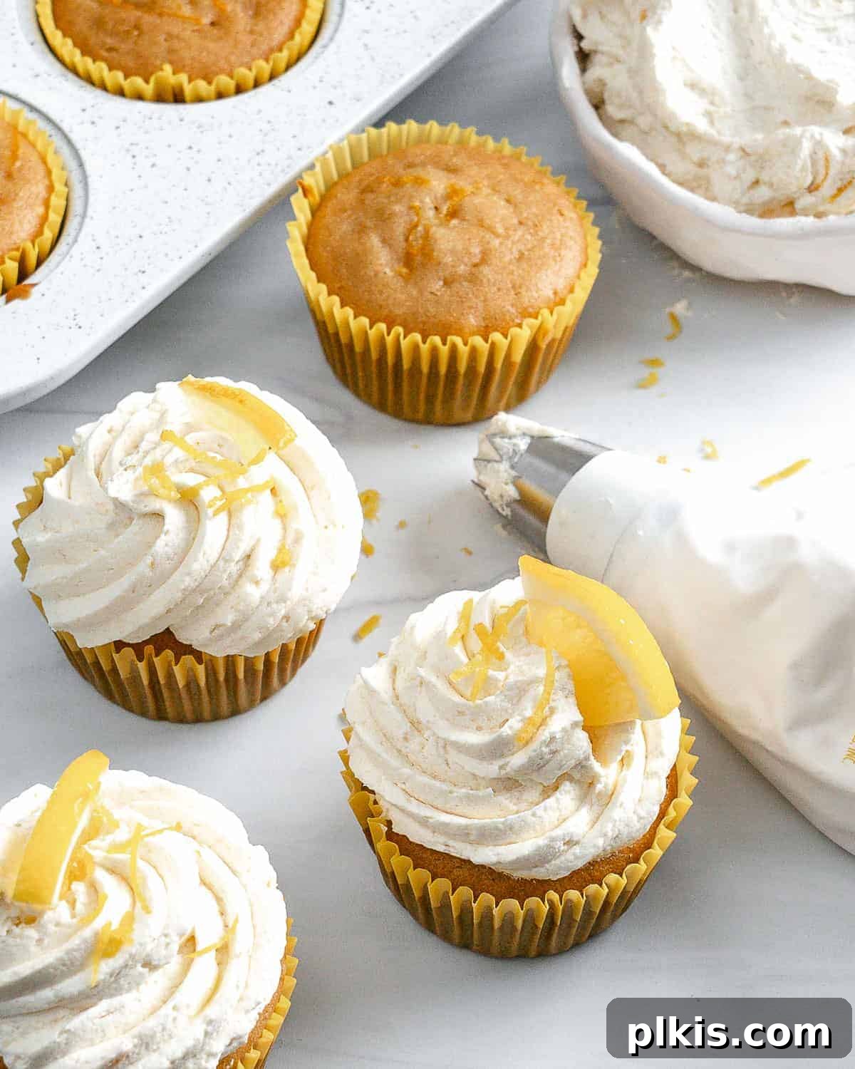 Effortless Vegan Lemon Cupcakes 7 A close-up shot of a single perfectly frosted vegan lemon cupcake, highlighting its beautiful texture.