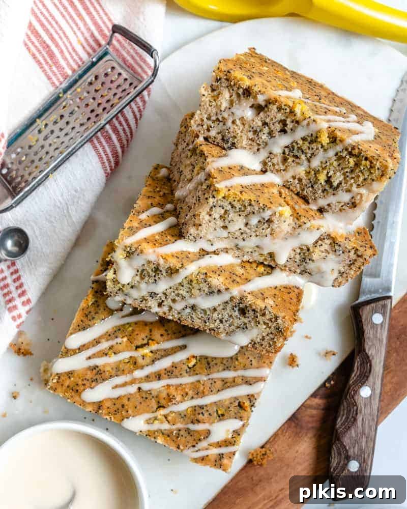 35 Irresistible Vegan Cake Creations 18 Four perfectly portioned squares of a golden lemon poppy seed cake arranged artfully on a white platter, ready for enjoyment.