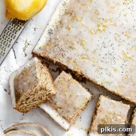 35 Irresistible Vegan Cake Creations 19 An overhead shot of a freshly baked lemon poppy seed cake, beautifully sliced and ready to serve.