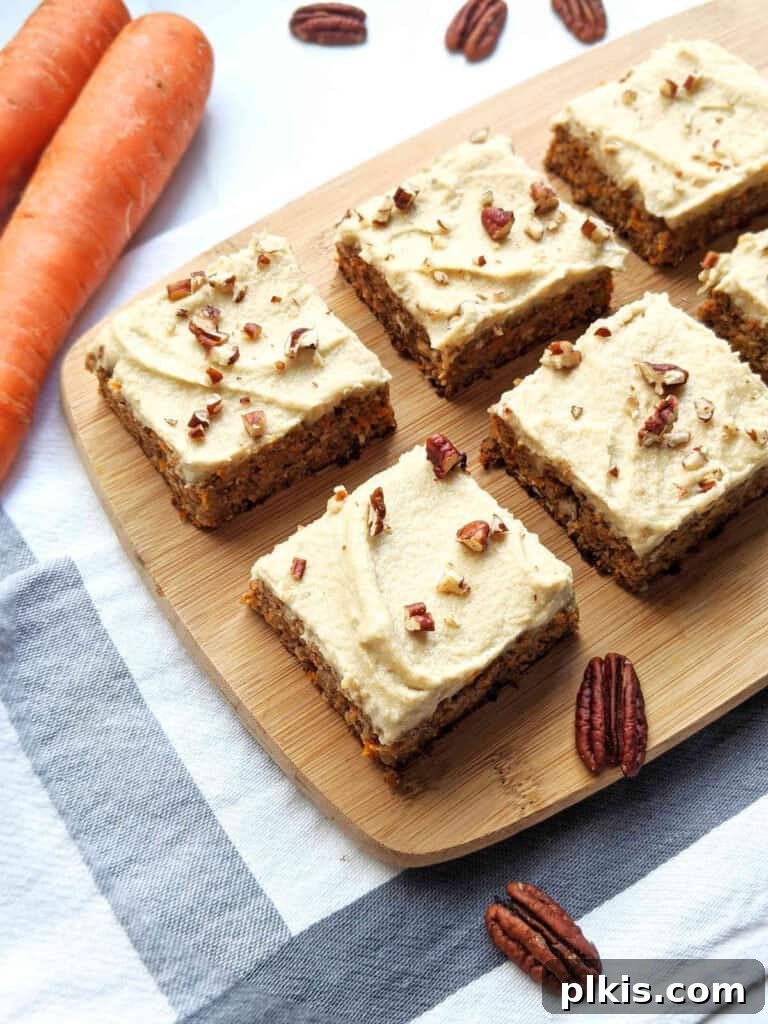 35 Irresistible Vegan Cake Creations 5 A delicious healthy vegan carrot cake, expertly sliced into square pieces and arranged on a rustic brown cutting board, showcasing its rich texture.