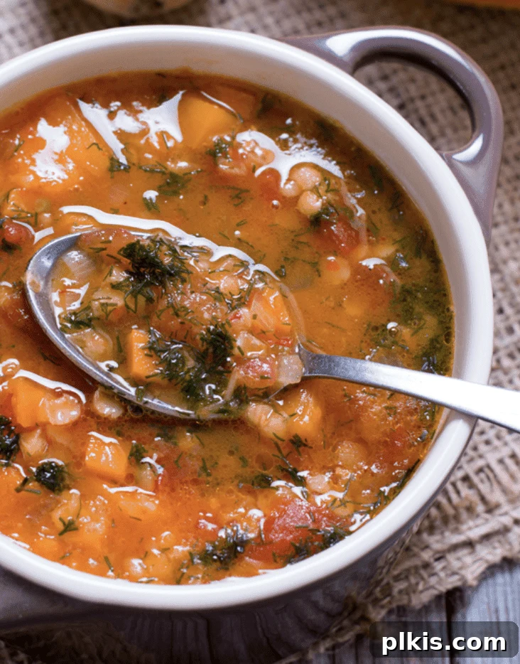 Over 30 Quick and Flavorful Vegan Instant Pot Recipes 23 completed Instant Pot Butternut Squash Chili in a pot with a spoonful in the forefront