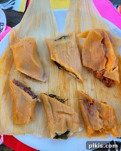 Over 30 Quick and Flavorful Vegan Instant Pot Recipes 27 completed vegan tamales halved on corn husk on a white plate