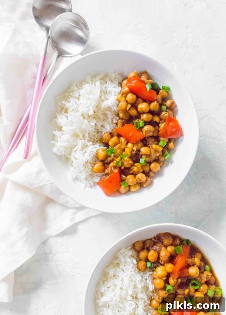 Over 30 Quick and Flavorful Vegan Instant Pot Recipes 29 completed Instant Pot Kung Pao Chickpeas plated in two white plates against a white background