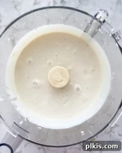 Layered Banana Dream 4 Post blending banana parfait mixture in a blender, showing a smooth, creamy texture