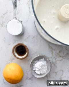 Layered Banana Dream 5 Ingredients for banana parfait measured out against a white marble surface, ready for blending