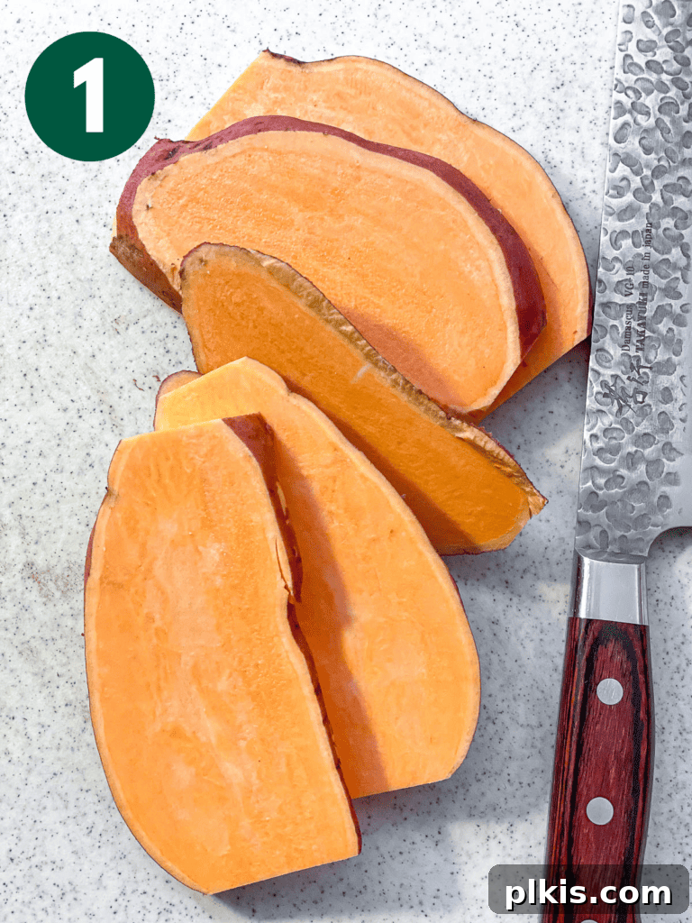 Signature Sweet Potato Sandwich 4 Process shot showing uniformly sliced sweet potatoes on a white cutting board.