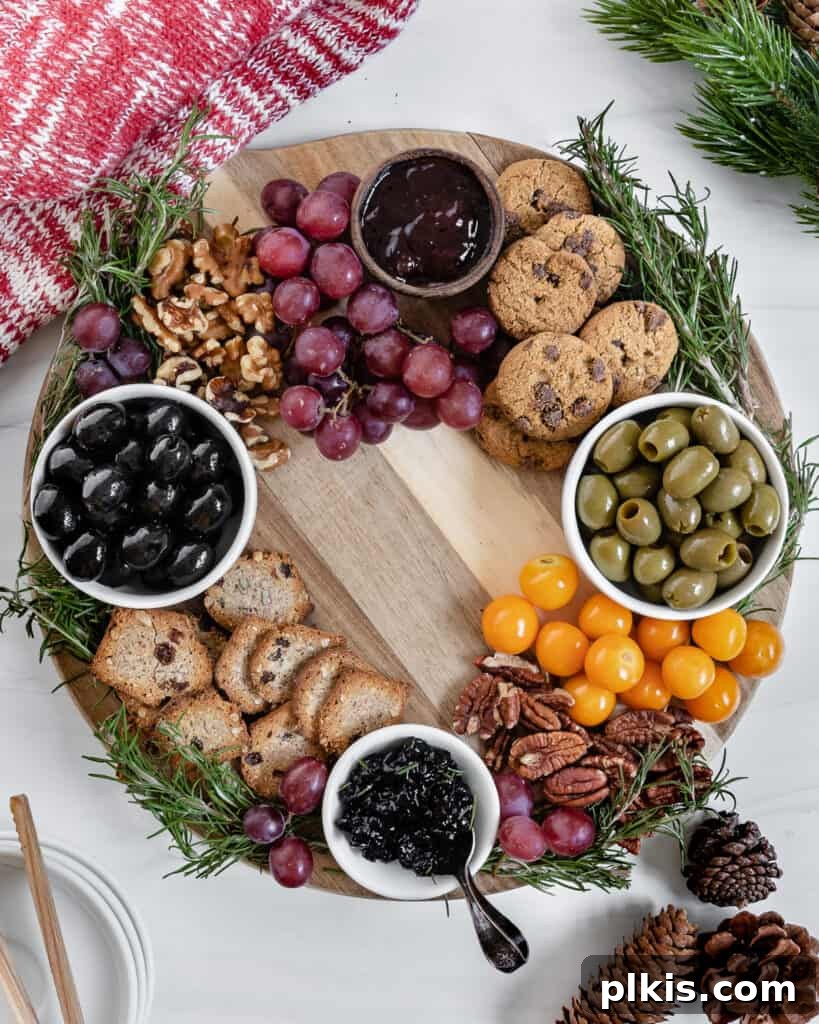 50 Quick Vegan Bites 9 A beautifully completed Christmas Wreath Charcuterie Board with several festive ingredients against a white background.